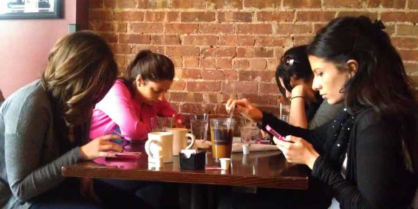 Ignoring friends at dinner on cell phones.